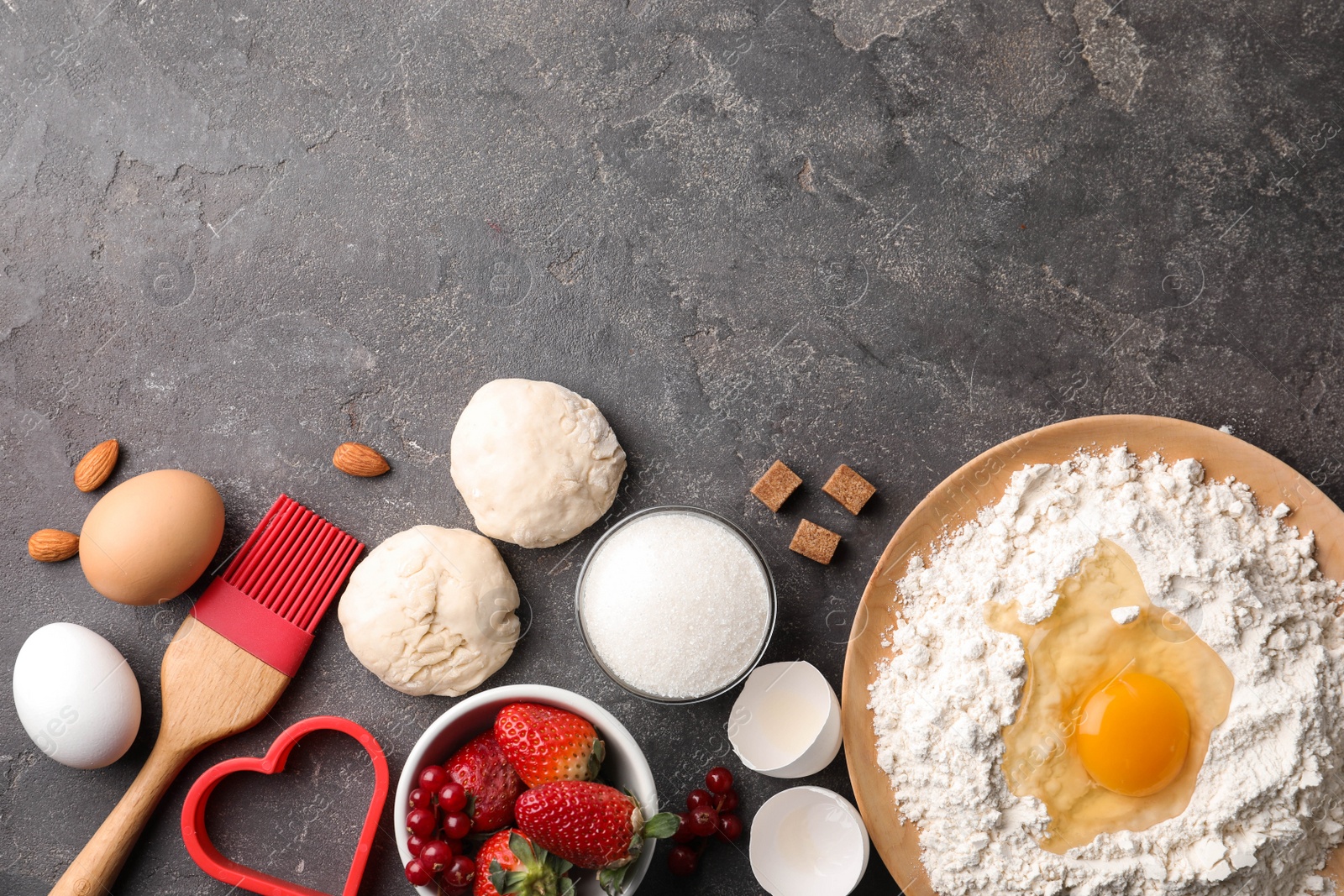 Photo of Flat lay composition with dough on grey table, space for text. Cooking pastries