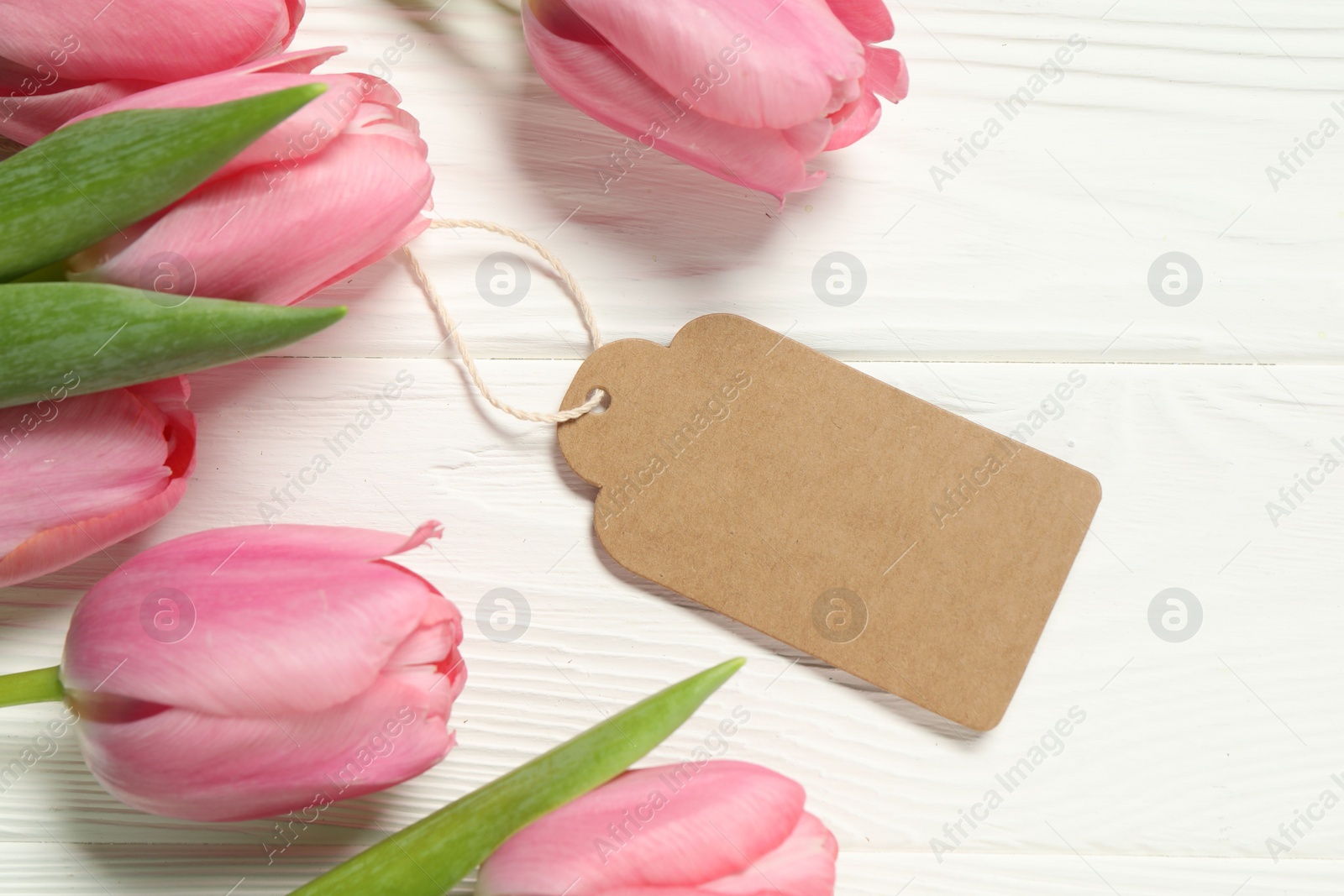 Photo of Happy Mother's Day. Beautiful tulips with blank card on white wooden table, flat lay