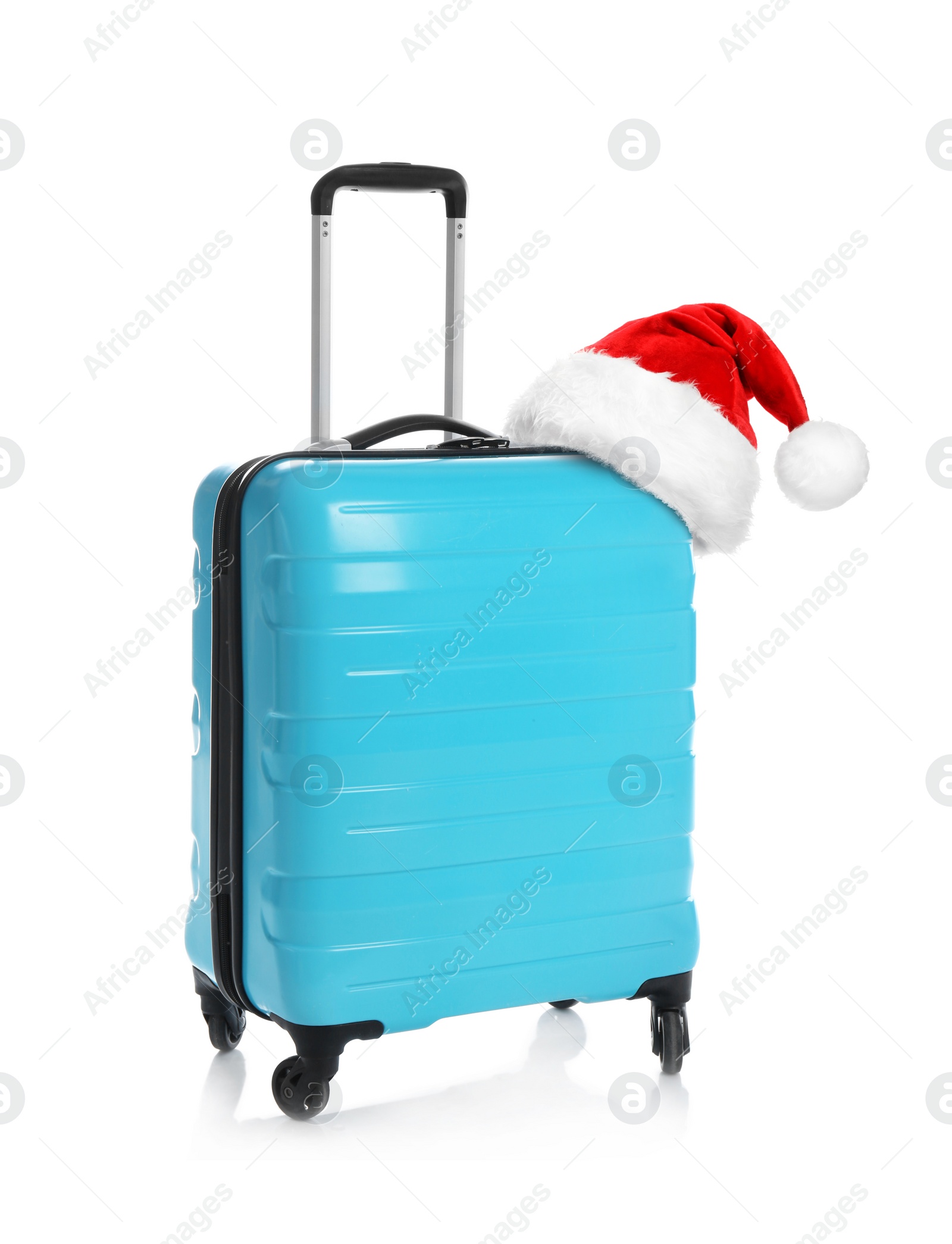 Image of Stylish suitcase with Santa Claus hat isolated on white. Christmas vacation 