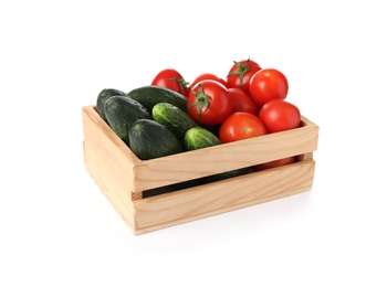 Wooden crate full of fresh vegetables on white background