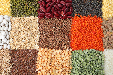 Photo of Different grains and cereals as background, top view