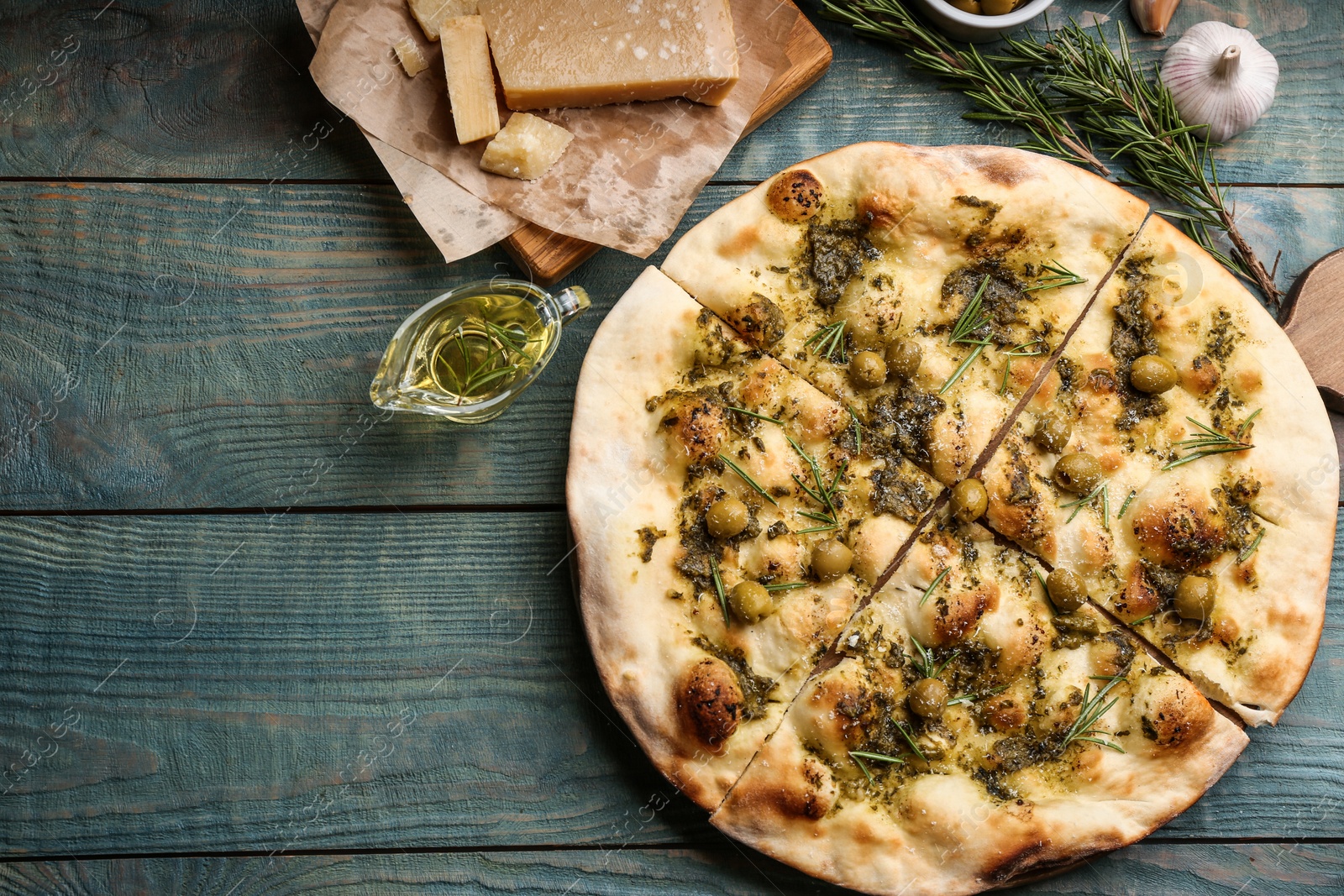 Photo of Flat lay composition with focaccia bread on  blue wooden table. Space for text