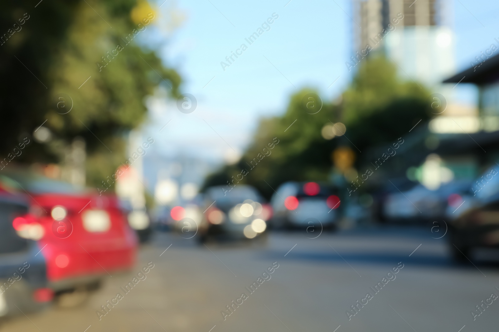 Photo of Blurred view of cityscape with cars on road. Bokeh effect