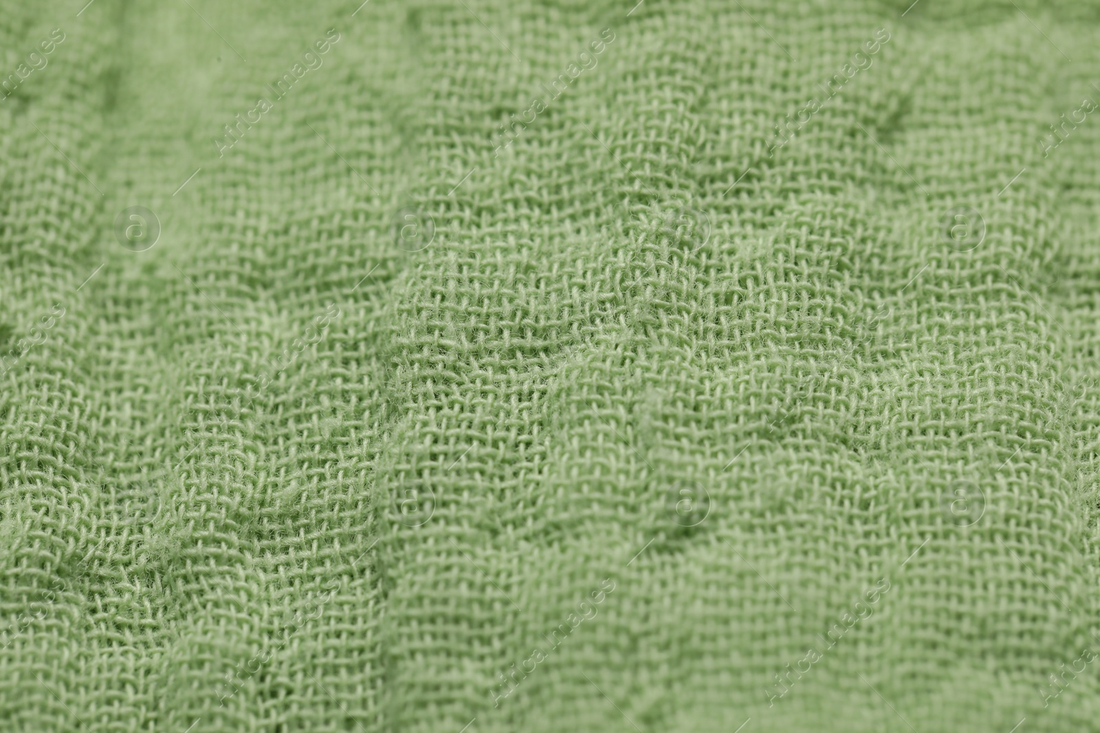 Photo of Texture of soft green fabric as background, closeup