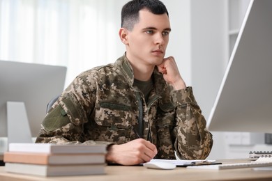 Photo of Military education. Young student learning at table indoors