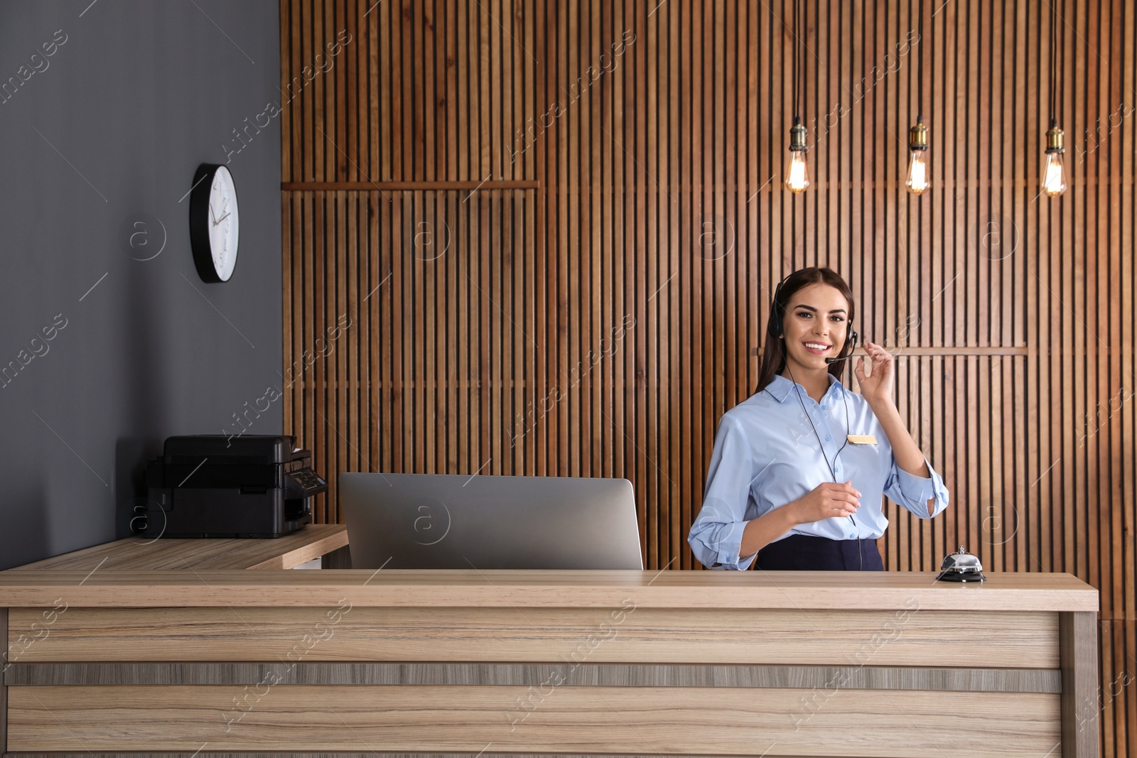 Photo of Portrait of receptionist with headset at desk in lobby