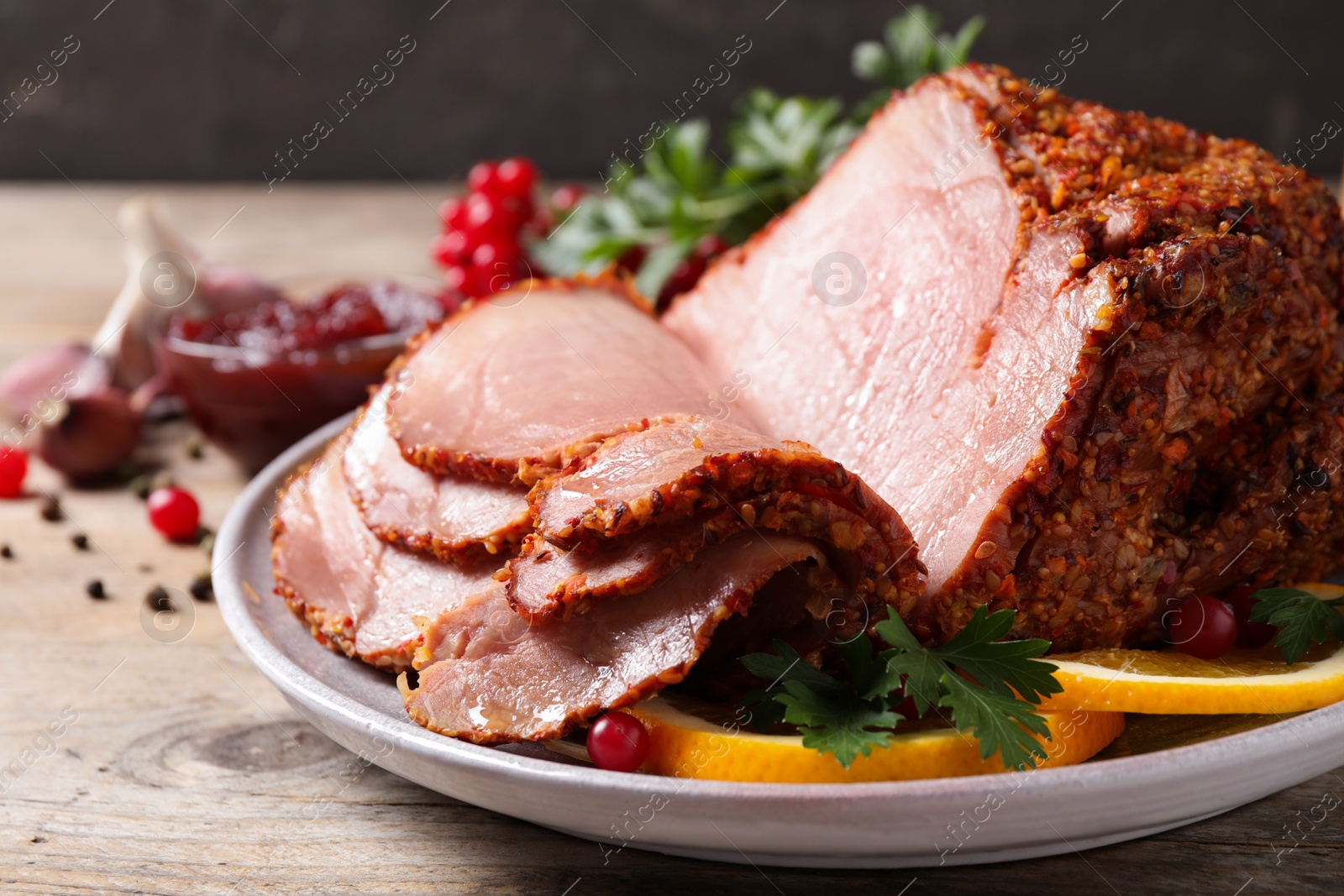 Photo of Delicious ham served with garnish on wooden table, closeup