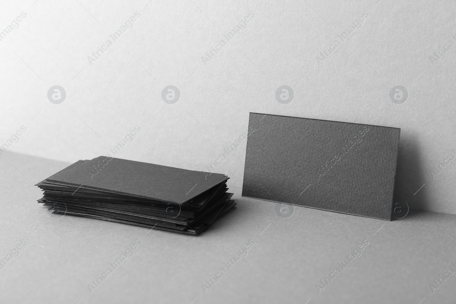 Photo of Blank black business cards on grey background. Mockup for design