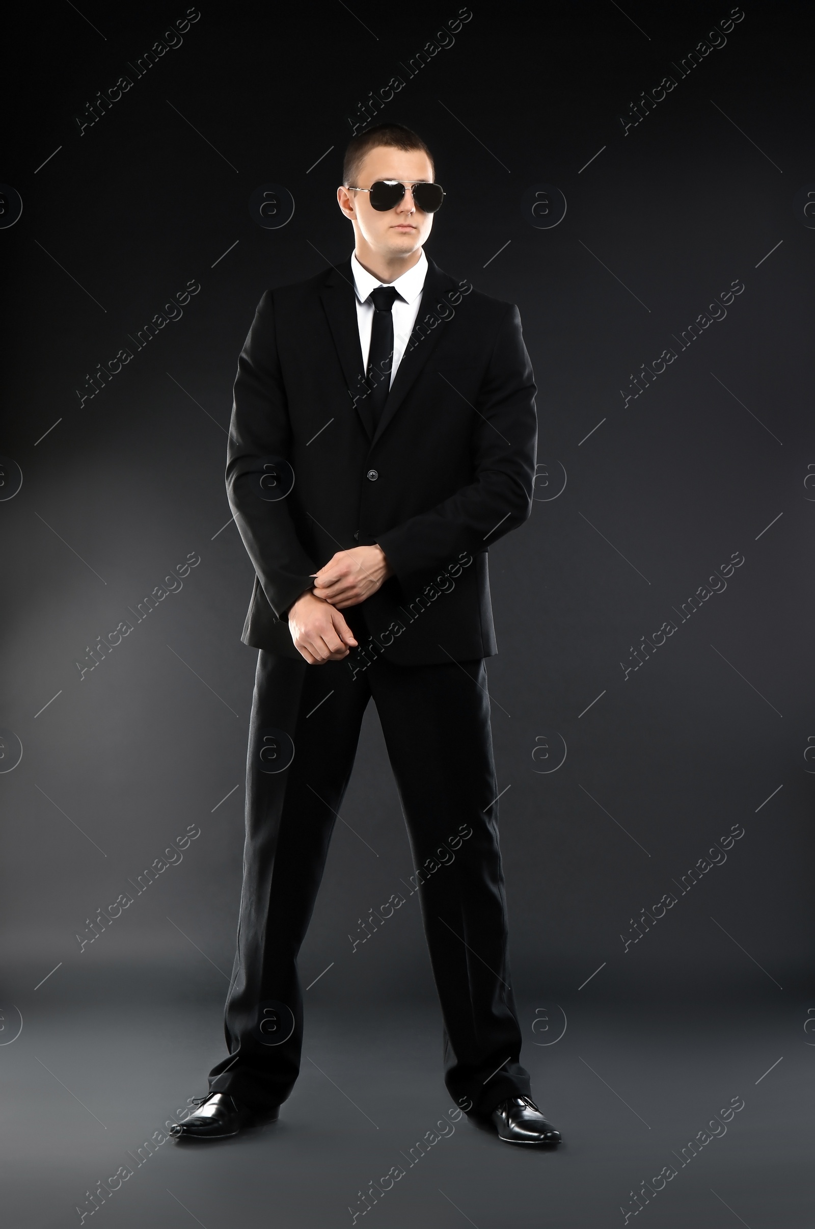 Photo of Male security guard in uniform on dark background