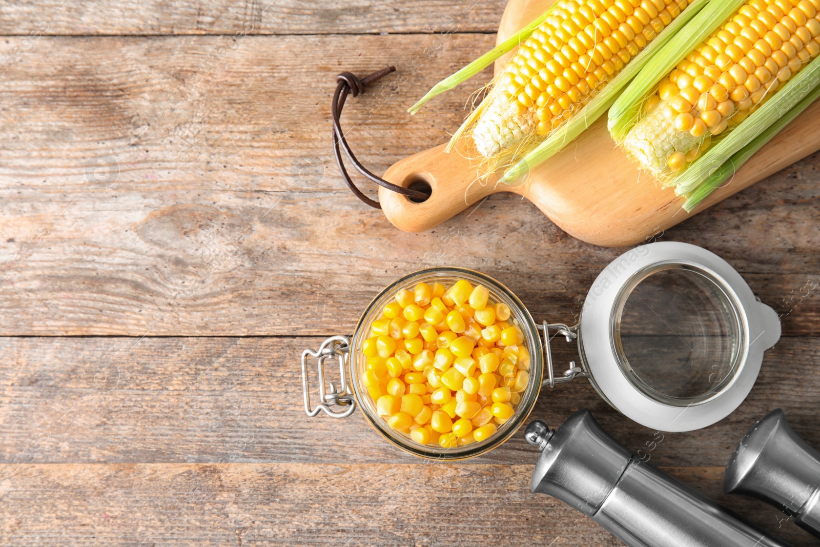 Photo of Flat lay composition with corn kernels on wooden background. Space for text