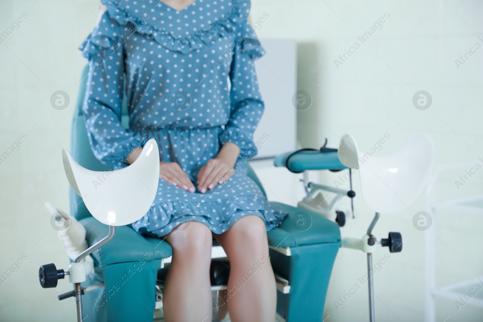 Photo of Gynecological checkup. Woman sitting on examination chair in hospital, selective focus