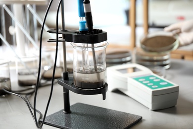 Photo of Measuring acidity and pH of soil on table. Laboratory analysis