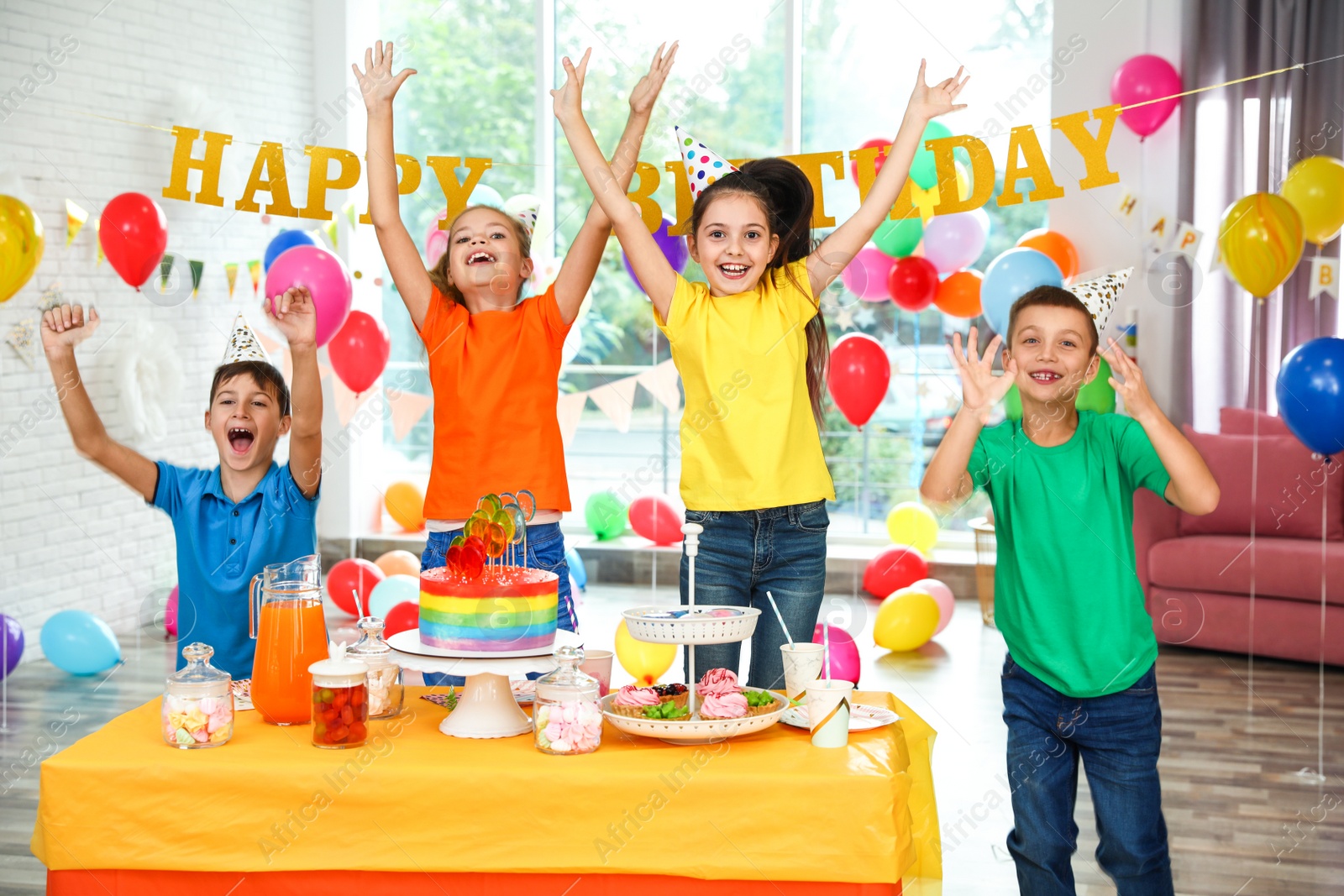 Photo of Happy children at birthday party in decorated room