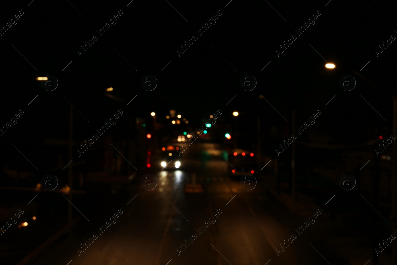 Photo of Blurred view of road with cars at night. Bokeh effect