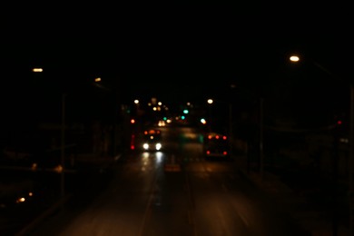 Photo of Blurred view of road with cars at night. Bokeh effect