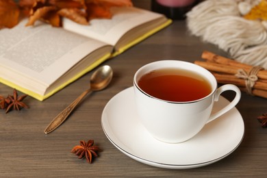 Photo of Composition with cup of hot tea on wooden table