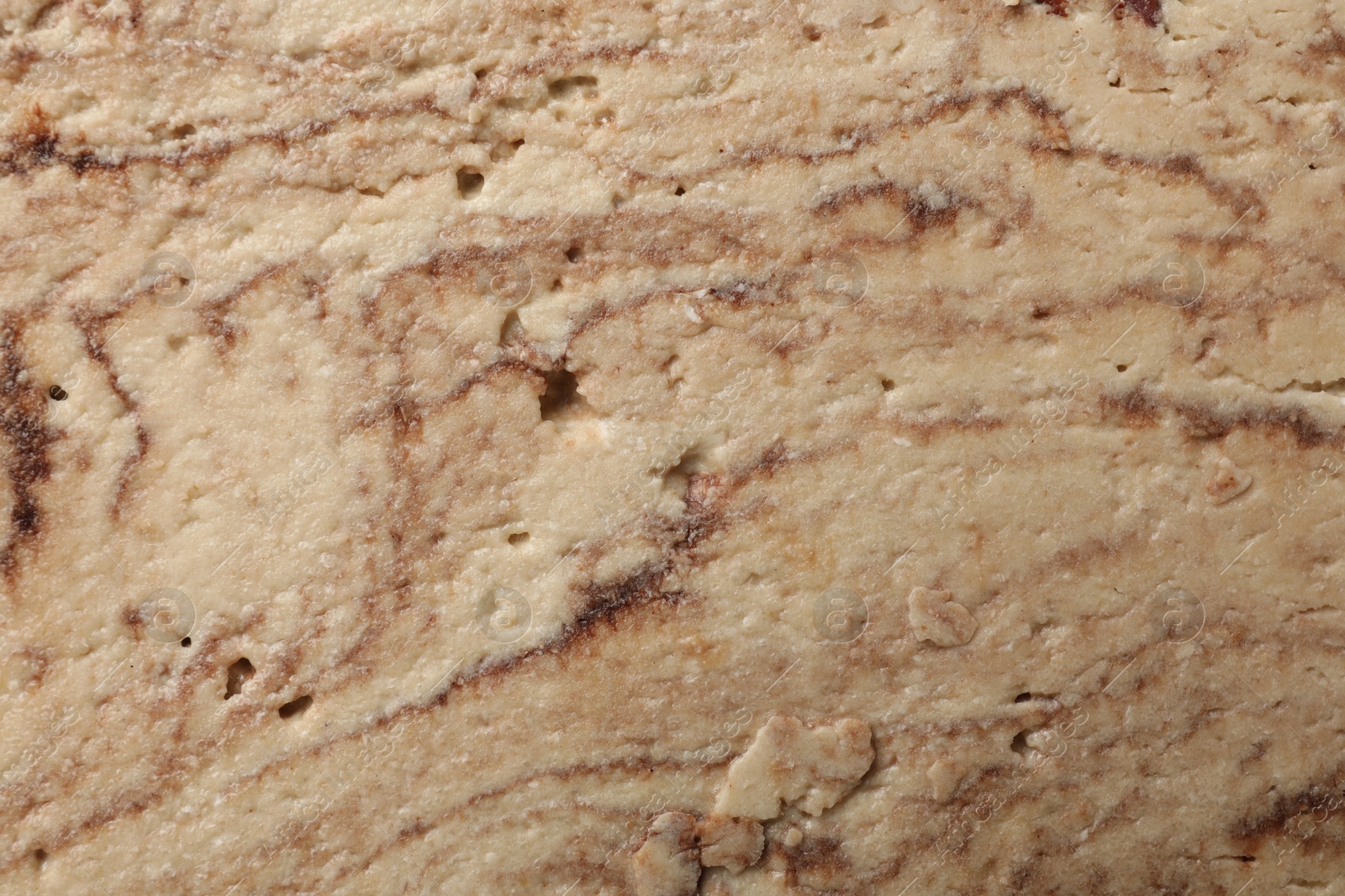 Photo of Tasty chocolate halva as background, closeup view