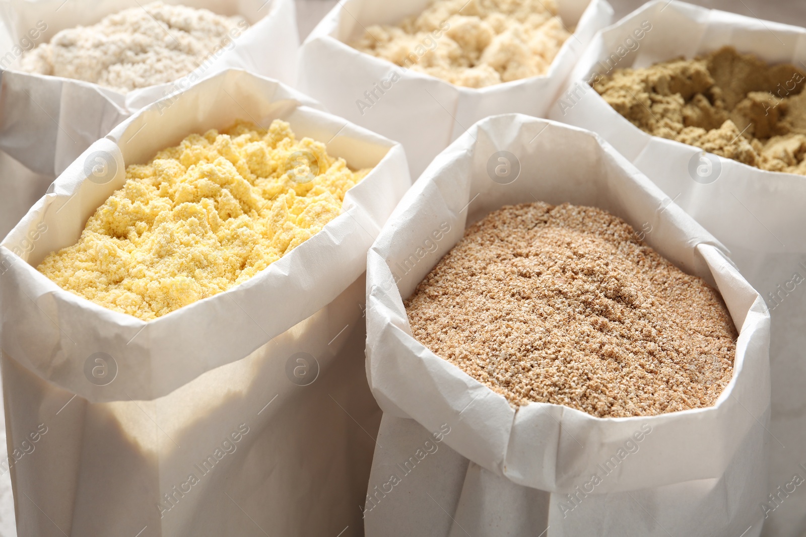 Photo of Different types of flour in paper bags