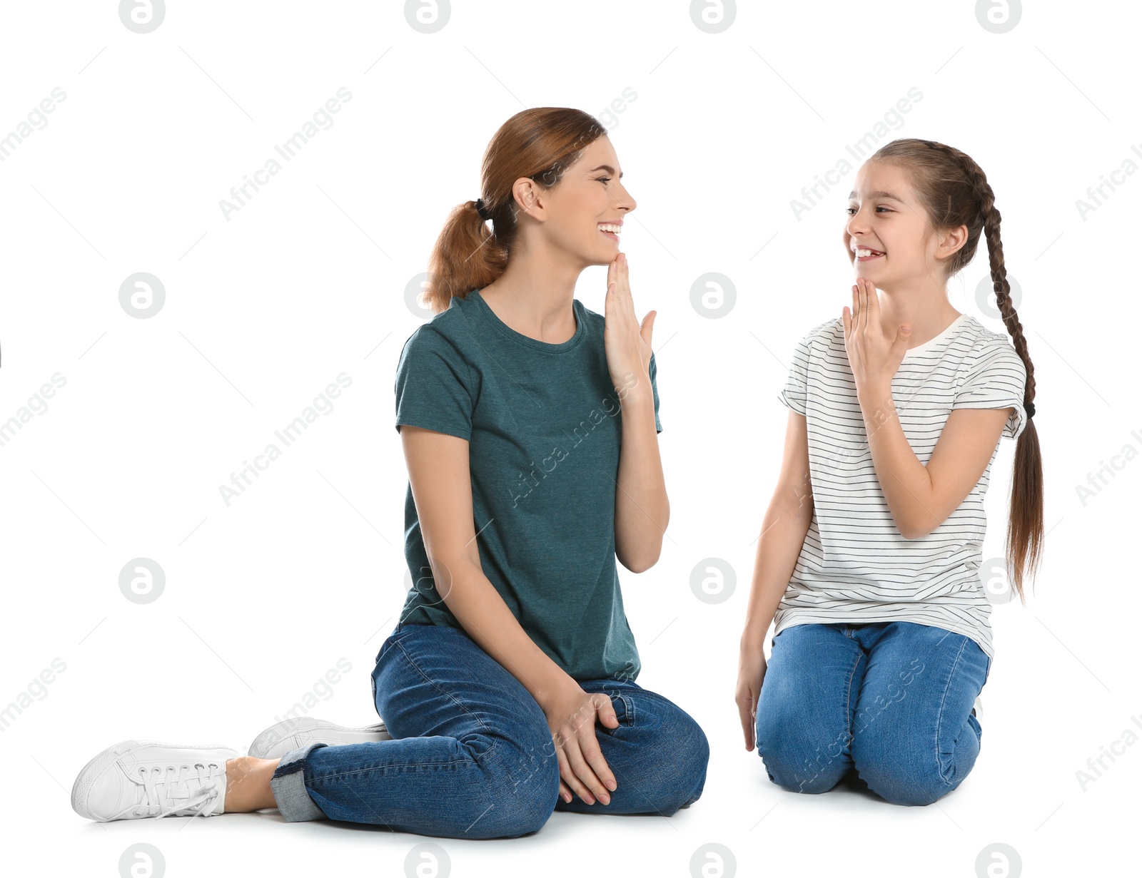 Photo of Hearing impaired mother and her child talking with help of sign language on white background