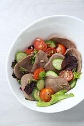 Photo of Delicious salad with beef tongue and vegetables on white wooden table, top view