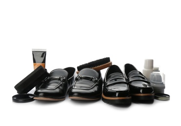 Photo of Stylish footwear and shoe care products on white background