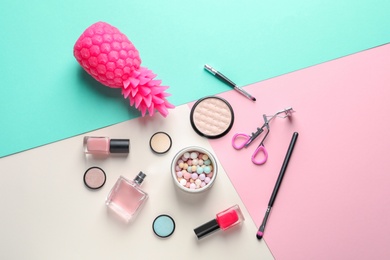 Flat lay composition with decorative cosmetics on color background