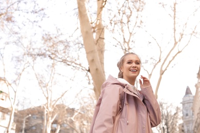 Portrait of happy young woman on city street