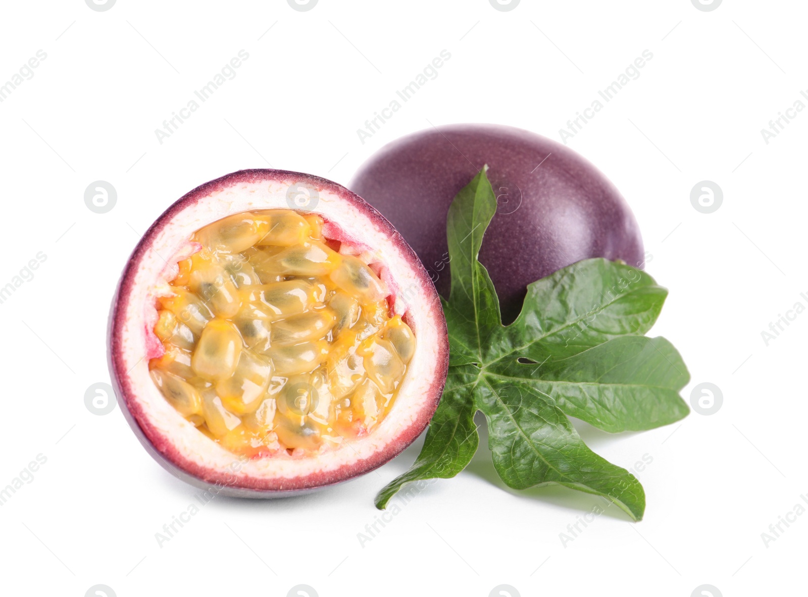 Photo of Cut and whole passion fruits with leaf isolated on white