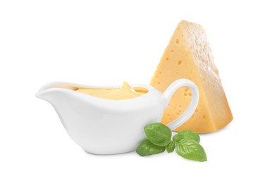 Tasty cheese, sauce and basil on white background