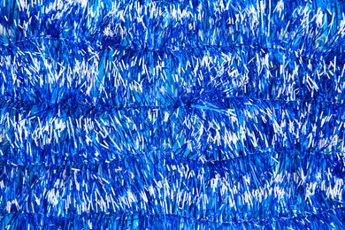 Bright blue tinsel as background. Festive decoration