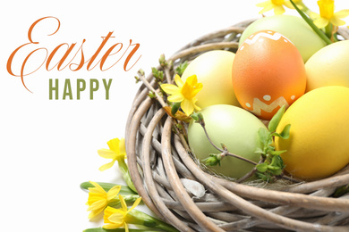 Image of Colorful eggs in decorative nest and text Happy Easter on white background, closeup