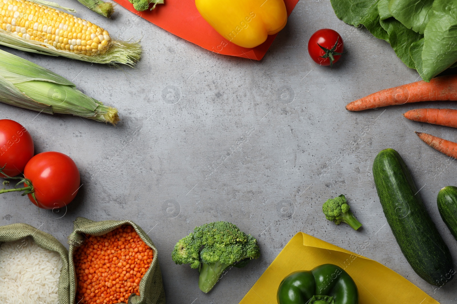 Photo of Frame of different fresh vegetables and seeds on grey table, flat lay. Space for text