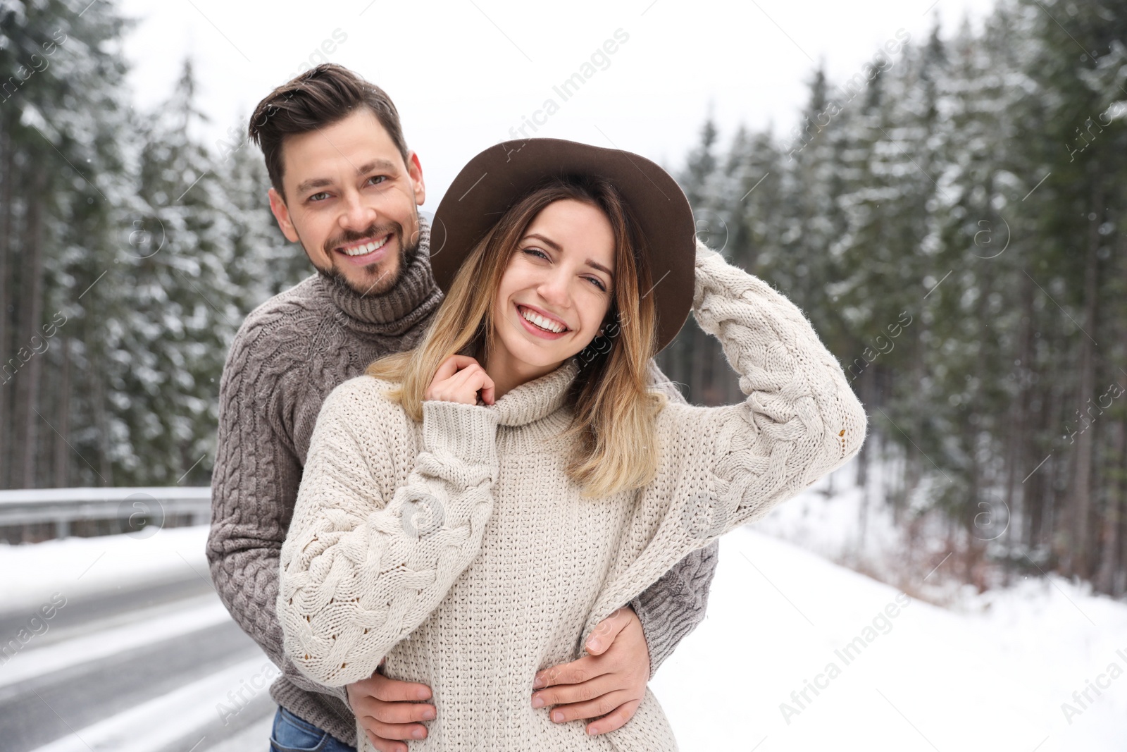 Photo of Cute couple outdoors on snowy day. Winter vacation