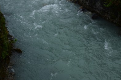 Photo of Beautiful mountain stream flowing outdoors, closeup view