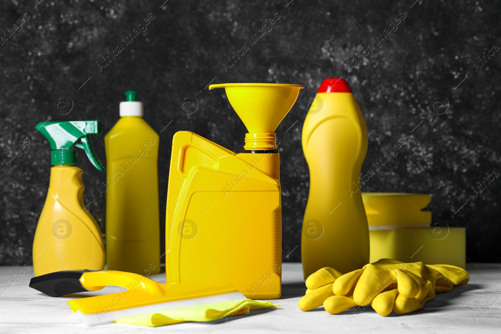 Photo of Car cleaning products, gloves and yellow canister with motor oil