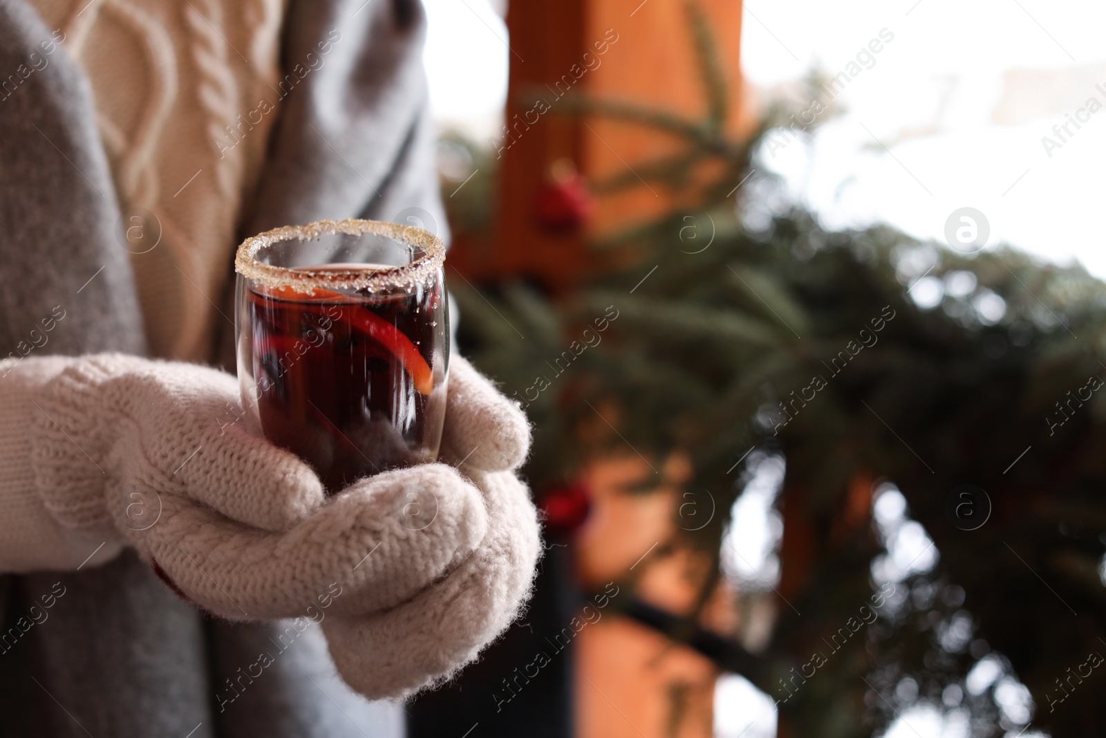 Photo of Woman with tasty mulled wine outdoors, closeup. Space for text