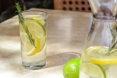 Photo of Tasty refreshing lemonade on light table. Summer drink