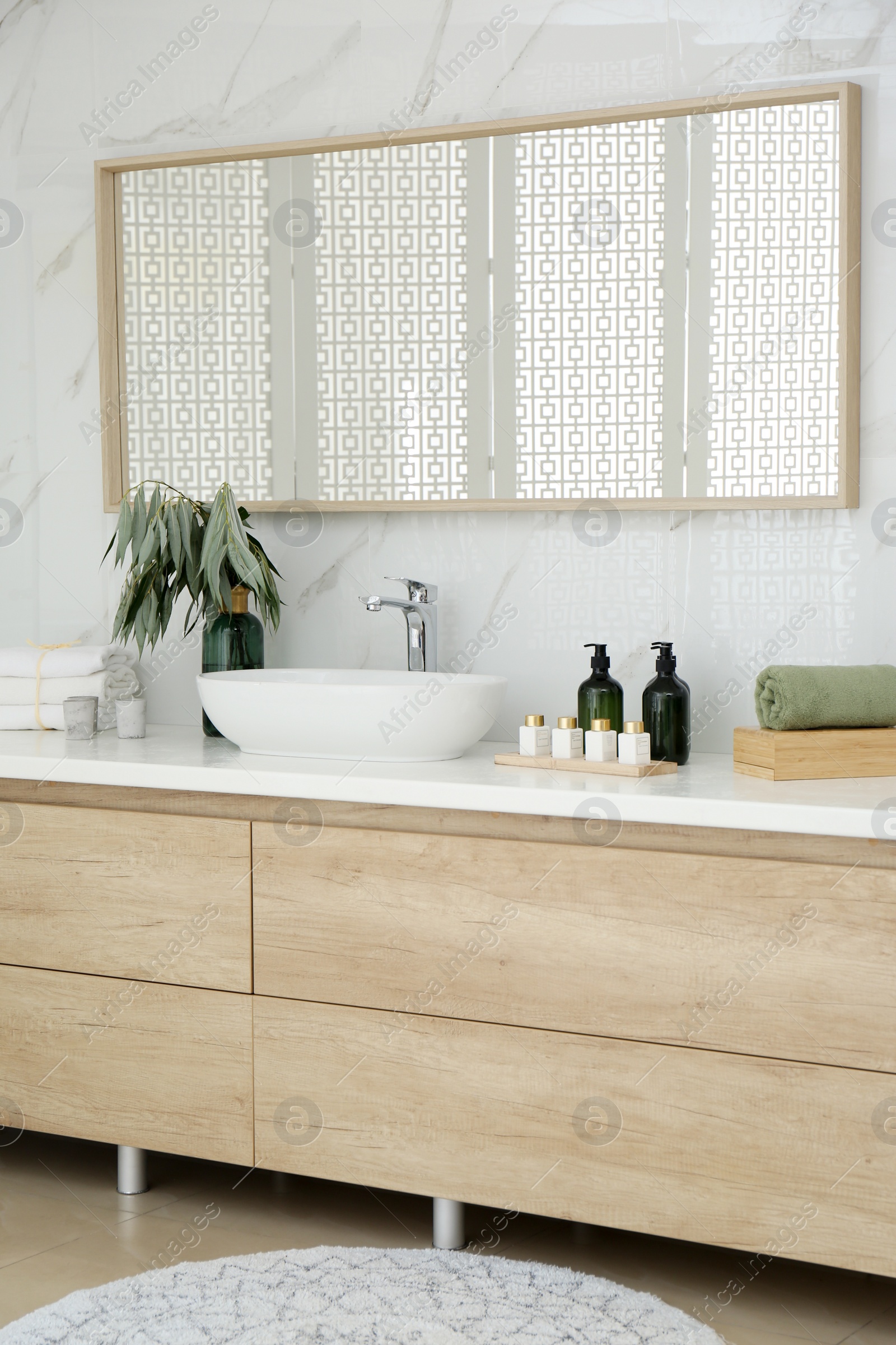 Photo of Modern bathroom interior with stylish mirror and vessel sink