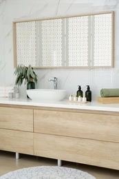 Modern bathroom interior with stylish mirror and vessel sink