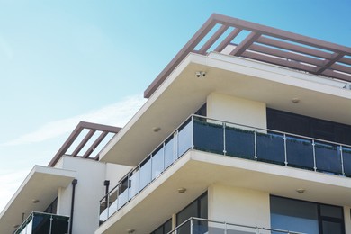 Exterior of building with balcony against blue sky, low angle view
