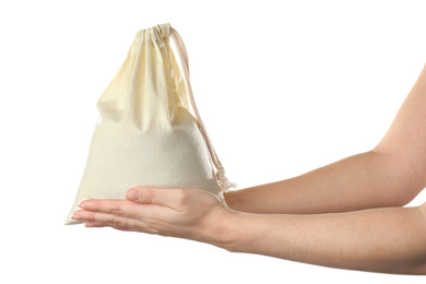 Photo of Woman holding full cotton eco bag on white background, closeup