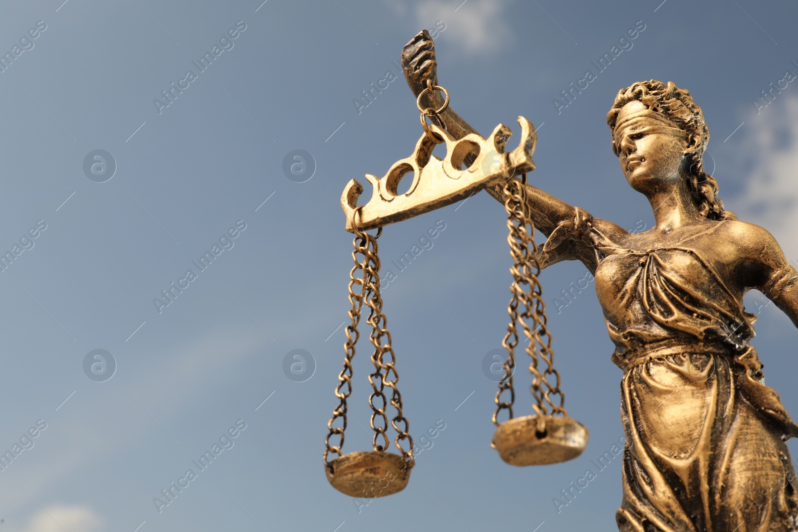 Photo of Symbol of fair treatment under law. Figure of Lady Justice against sky, closeup with space for text