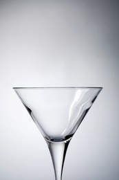 Elegant empty martini glass on grey background, closeup. Space for text