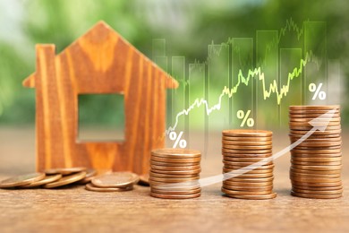 Image of Mortgage rate. Model of house, stacked coins, graphs, percent signs and arrow