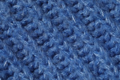 Photo of Texture of soft blue knitted fabric as background, closeup