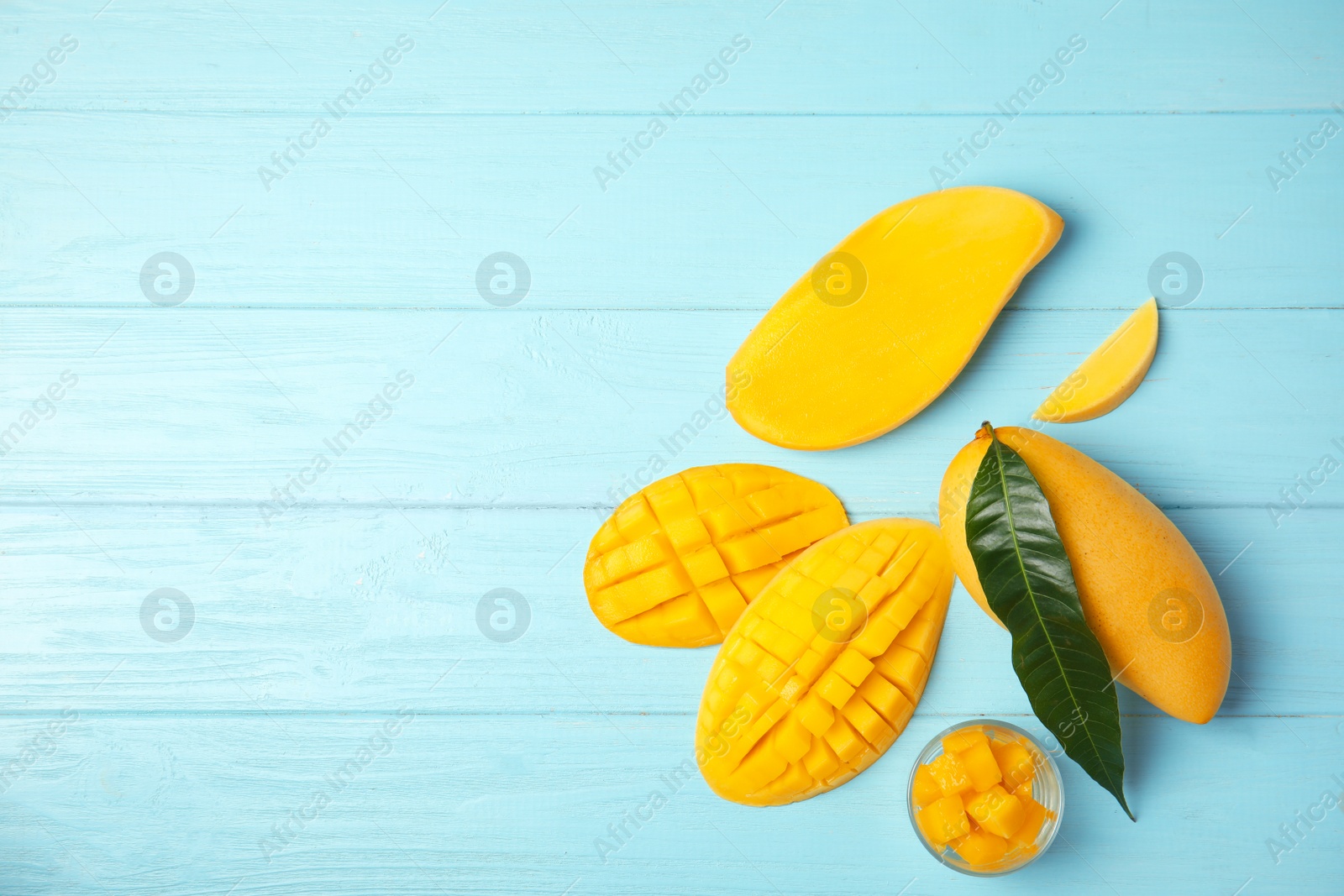 Photo of Flat lay composition with mango on wooden background. Space for text