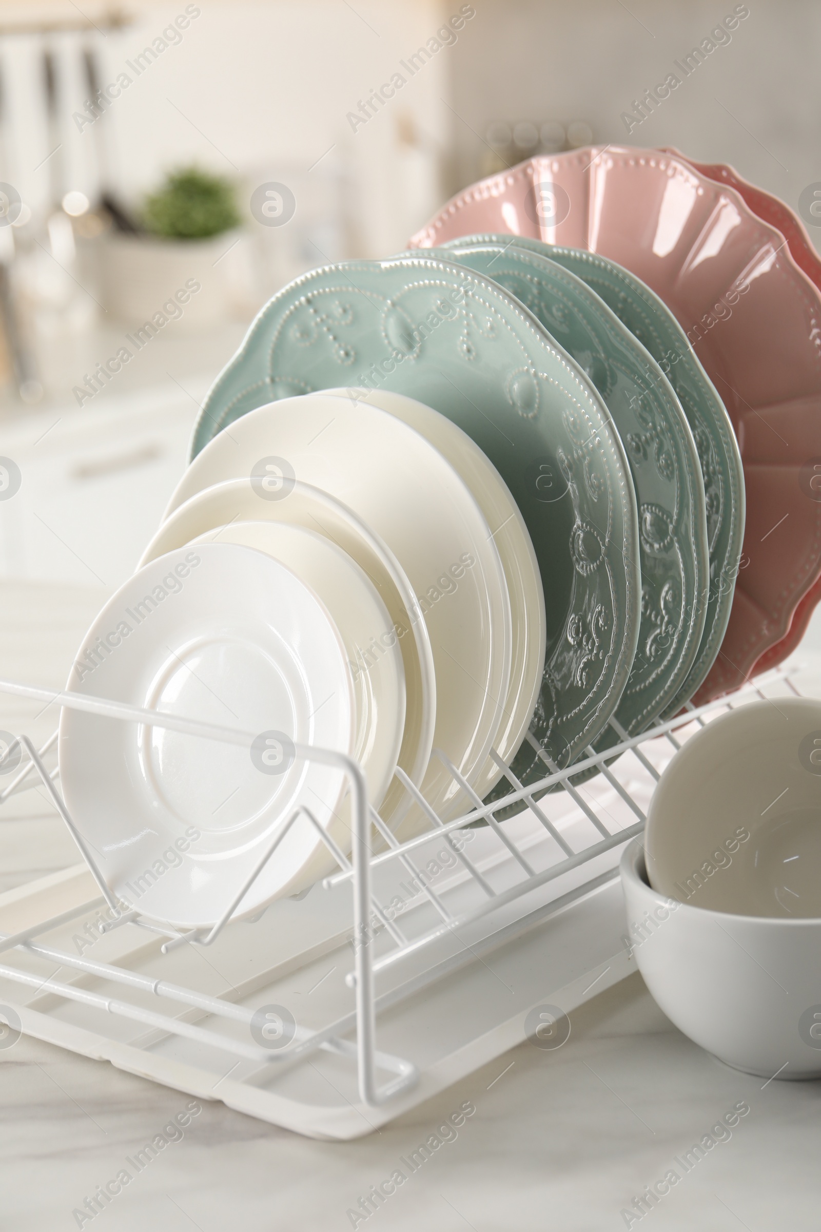 Photo of Many different clean dishware on white table indoors