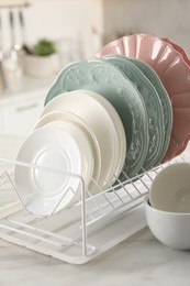 Many different clean dishware on white table indoors