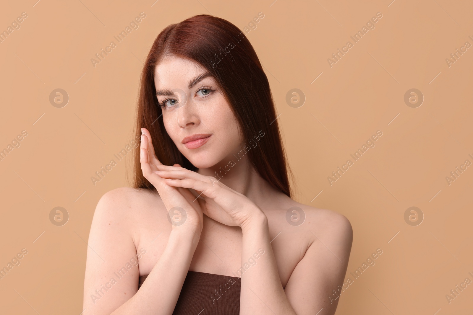 Photo of Portrait of beautiful woman on beige background