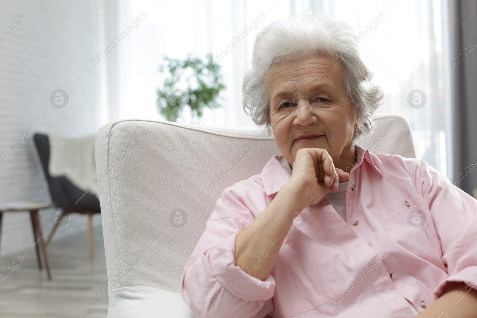 Photo of Portrait of mature woman in living room